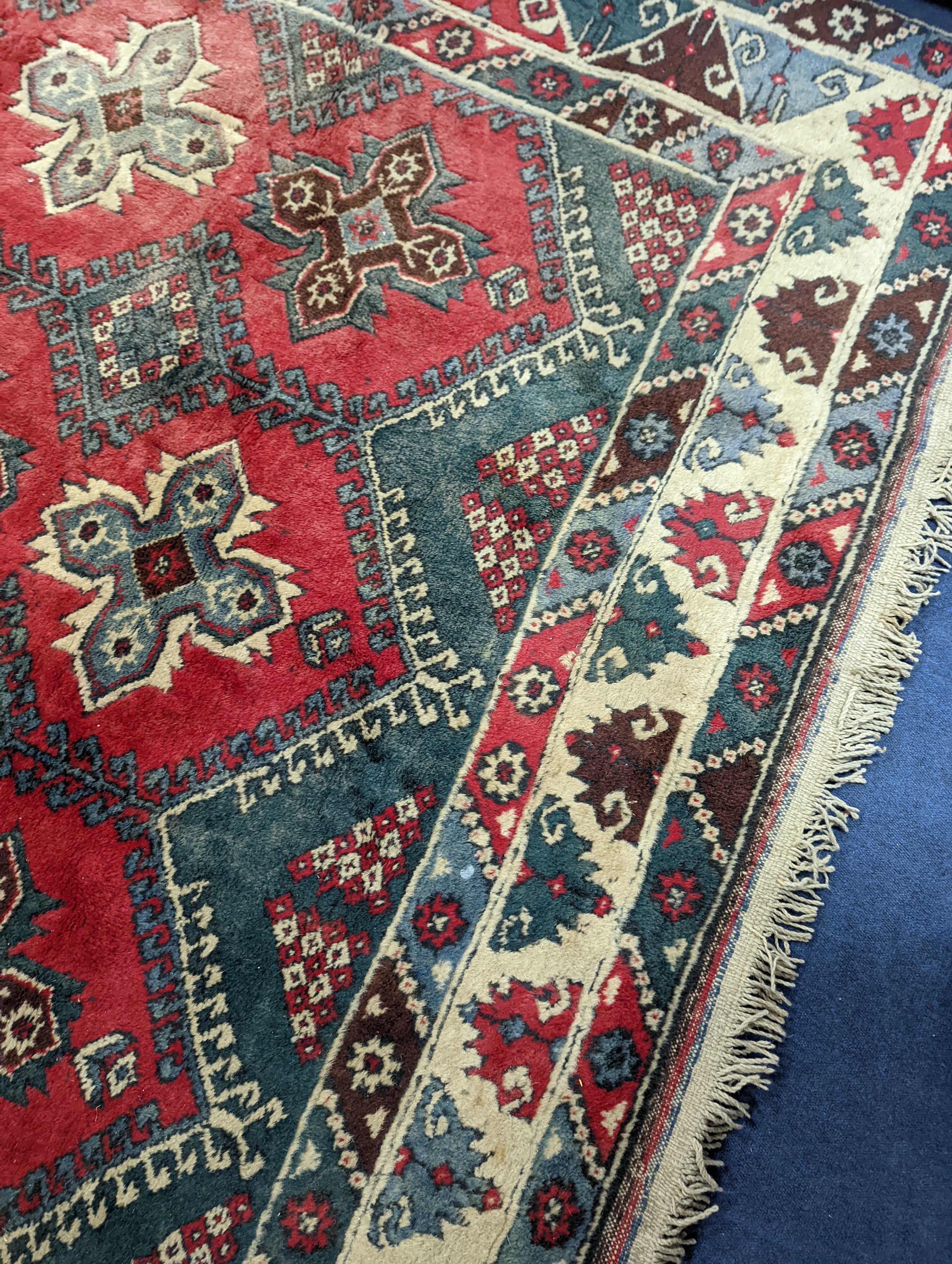 A Caucasian style red ground carpet, 286 x 210cm